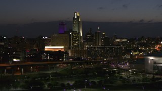 DX0002_173_014 - 5.7K aerial stock footage of slowly flying by the city's skyline at twilight, Downtown Omaha, Nebraska