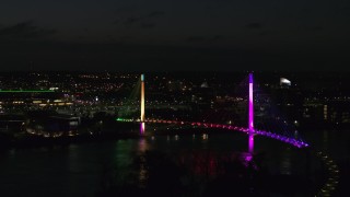 DX0002_173_023 - 5.7K stock footage aerial video of circling a pedestrian bridge spanning the Missouri River at night, Omaha, Nebraska