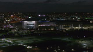 DX0002_173_024 - 5.7K aerial stock footage orbit and approach arena and convention center complex at night, Downtown Omaha, Nebraska