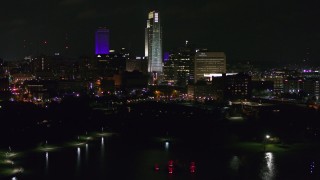 DX0002_173_048 - 5.7K aerial stock footage of slowly ascending toward tall skyscrapers at night, Downtown Omaha, Nebraska