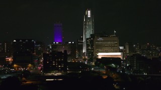 DX0002_173_056 - 5.7K aerial stock footage of towering skyscrapers and high-rises at night, Downtown Omaha, Nebraska