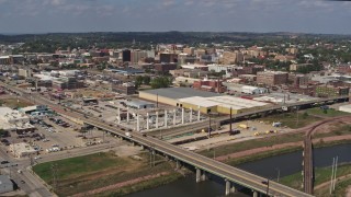 DX0002_174_003 - 5.7K stock footage aerial video ascend and fly away from bridges and riverfront warehouses near downtown, Sioux City, Iowa