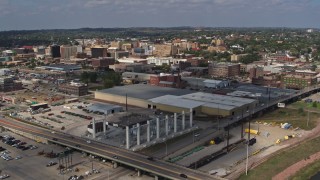 DX0002_174_006 - 5.7K aerial stock footage descend and fly away from riverfront warehouses near downtown, reveal river, Sioux City, Iowa