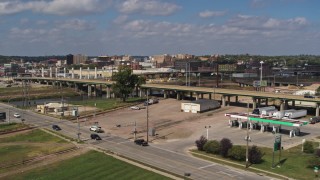 DX0002_174_007 - 5.7K aerial stock footage flying by the Gordon Drive bridge and a gas station, Sioux City, Iowa