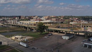 DX0002_174_008 - 5.7K stock footage aerial video ascend by bridge for view of warehouse and downtown, Sioux City, Iowa