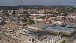 DX0002_174_009 - 5.7K aerial stock footage flyby and away from warehouses with view of downtown, Sioux City, Iowa