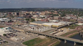 DX0002_174_010 - 5.7K aerial stock footage reverse view of warehouses and downtown, seen from river, Sioux City, Iowa
