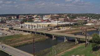 DX0002_174_011 - 5.7K aerial stock footage descend by bridges with view of warehouses and downtown, Sioux City, Iowa
