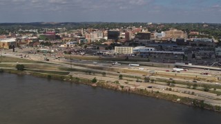 DX0002_174_015 - 5.7K aerial stock footage of office buildings and I-29 seen while descending by the river, Downtown Sioux City, Iowa