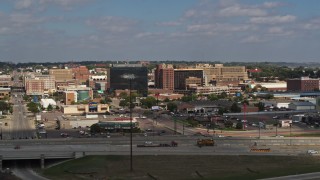 DX0002_174_028 - 5.7K aerial stock footage of passing by office buildings and fast food restaurants near the highway in Downtown Sioux City, Iowa