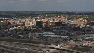 DX0002_174_030 - 5.7K aerial stock footage reverse view of office buildings in Downtown Sioux City, Iowa, descend toward river