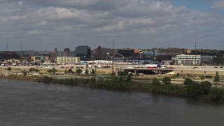DX0002_174_032 - 5.7K aerial stock footage fly over Missouri River and ascend for view of office buildings in Downtown Sioux City, Iowa