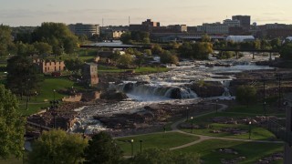 DX0002_176_002 - 5.7K aerial stock footage of an orbit of the falls at Falls Park at sunset in Sioux Falls, South Dakota