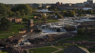 DX0002_176_003 - 5.7K aerial stock footage of circling the falls at Falls Park at sunset in Sioux Falls, South Dakota