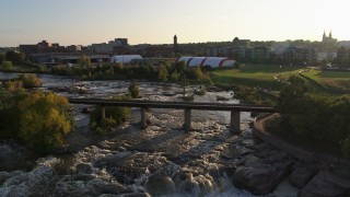 DX0002_176_014 - 5.7K aerial stock footage bridge spanning the river at sunset in Sioux Falls, South Dakota