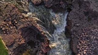 DX0002_176_017 - 5.7K aerial stock footage a bird's eye view of rapids on the river at sunset in Sioux Falls, South Dakota