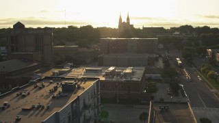 DX0002_176_028 - 5.7K aerial stock footage orbit county office buildings, cathedral in background at sunset in Downtown Sioux Falls, South Dakota