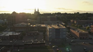 DX0002_176_030 - 5.7K aerial stock footage pass by apartment, county office buildings, cathedral at sunset in Downtown Sioux Falls, South Dakota
