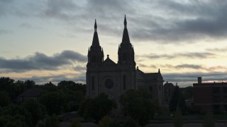DX0002_176_037 - 5.7K aerial stock footage circling the Cathedral of Saint Joseph at twilight in Sioux Falls, South Dakota
