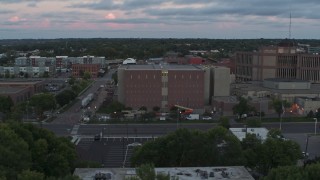 DX0002_176_039 - 5.7K aerial stock footage of circling a county government building at twilight, Downtown Sioux Falls, South Dakota