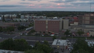 DX0002_176_040 - 5.7K aerial stock footage of orbiting a county government building at twilight, Downtown Sioux Falls, South Dakota