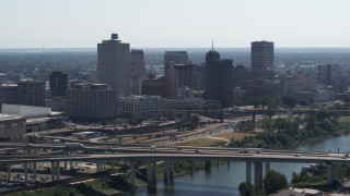 DX0002_177_003 - 5.7K aerial stock footage of the city's skyline seen while flying by a bridge in Downtown Memphis, Tennessee