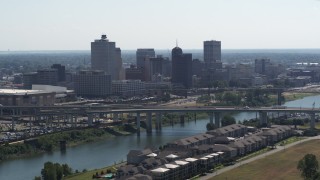 DX0002_177_007 - 5.7K aerial stock footage ascending from apartment buildings with view of the city's skyline and bridge in Downtown Memphis, Tennessee