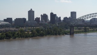 DX0002_177_013 - 5.7K aerial stock footage of the skyline and bridge seen from the river in Downtown Memphis, Tennessee