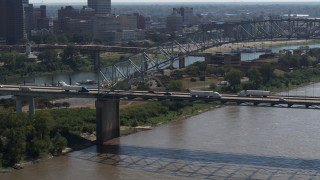 DX0002_177_017 - 5.7K aerial stock footage of cars and trucks crossing the bridge spanning the Mississippi River, Memphis, Tennessee