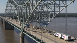 DX0002_177_029 - 5.7K aerial stock footage of following cars crossing the bridge under a sign, Memphis, Tennessee