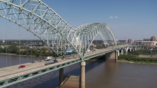 DX0002_178_021 - 5.7K aerial stock footage flying by cars crossing the bridge to Memphis, Tennessee