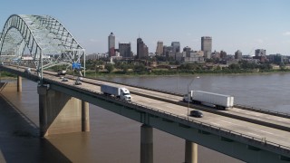 DX0002_178_033 - 5.7K aerial stock footage flyby bridge traffic with a view of the skyline of Downtown Memphis, Tennessee
