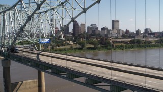 DX0002_178_034 - 5.7K aerial stock footage passing bridge traffic with a view of the skyline of Downtown Memphis, Tennessee