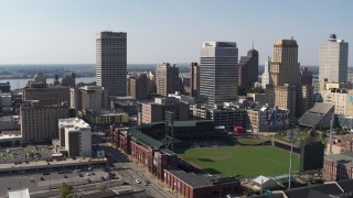 DX0002_179_013 - 5.7K aerial stock footage descend with view of baseball stadium and high-rise office towers in Downtown Memphis, Tennessee