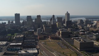 DX0002_179_035 - 5.7K aerial stock footage descending past tall high-rise office buildings in Downtown Memphis, Tennessee skyline