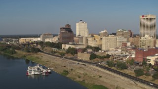 DX0002_180_018 - 5.7K aerial stock footage reverse view of Raymond James Tower and office buildings near the water, Downtown Memphis, Tennessee