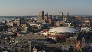 DX0002_180_021 - 5.7K aerial stock footage of approaching FedEx Forum arena and city skyline at sunset, Downtown Memphis, Tennessee