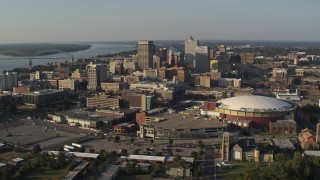 DX0002_180_023 - 5.7K aerial stock footage of a view of FedEx Forum arena and the city skyline at sunset, Downtown Memphis, Tennessee