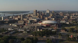 DX0002_180_025 - 5.7K aerial stock footage of a view of the city skyline seen while flying away from FedEx Forum arena, sunset, Downtown Memphis, Tennessee