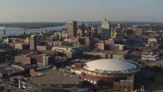 DX0002_180_028 - 5.7K aerial stock footage ascend and approach the city skyline and FedEx Forum arena at sunset, Downtown Memphis, Tennessee