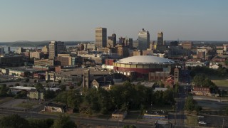 DX0002_180_031 - 5.7K aerial stock footage the city skyline and FedEx Forum arena at sunset during descent, Downtown Memphis, Tennessee