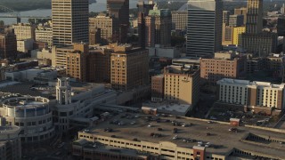 DX0002_180_038 - 5.7K aerial stock footage ascend over FedEx Forum arena at sunset toward hotel in Downtown Memphis, Tennessee