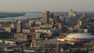 DX0002_181_006 - 5.7K aerial stock footage of a reverse view of tall office towers and the arena at sunset, Downtown Memphis, Tennessee