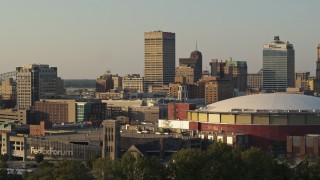 DX0002_181_009 - 5.7K aerial stock footage of One Commerce Square office tower at sunset, descend by arena, Downtown Memphis, Tennessee