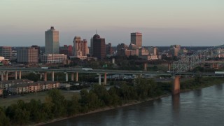 DX0002_181_020 - 5.7K aerial stock footage focus on the city's skyline as traffic crosses the bridge at sunset, Downtown Memphis, Tennessee