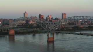 DX0002_181_021 - 5.7K aerial stock footage of the city's skyline as traffic crosses the bridge at sunset, Downtown Memphis, Tennessee