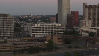 DX0002_181_037 - 5.7K aerial stock footage of a reverse view of Memphis City Hall at sunset in Downtown Memphis, Tennessee