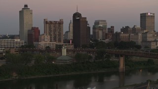 DX0002_181_038 - 5.7K aerial stock footage fly away from and by apartment and office high-rises at sunset in Downtown Memphis, Tennessee