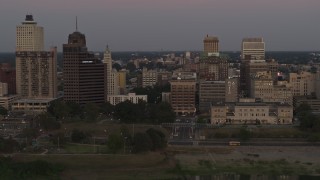 DX0002_181_040 - 5.7K aerial stock footage Raymond Jame Tower and office buildings at sunset in Downtown Memphis, Tennessee