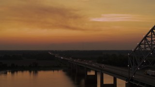 DX0002_181_045 - 5.7K aerial stock footage fly beside the Hernando de Soto Bridge at sunset, approach Arkansas